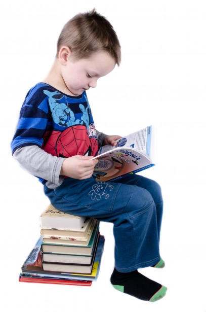 schoolboy is sitting on books | Toddlebabes - Learn to Play - Play to Learn