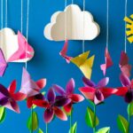 Origami paper flowers, butterflies, clouds and sun. Paper art craft