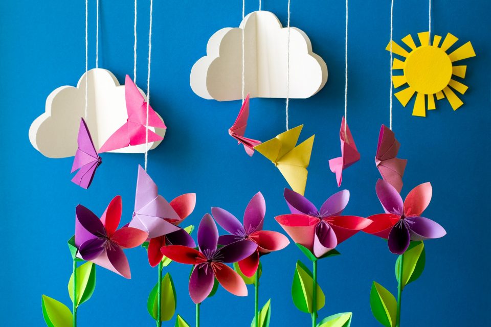 Origami paper flowers, butterflies, clouds and sun. Paper art craft